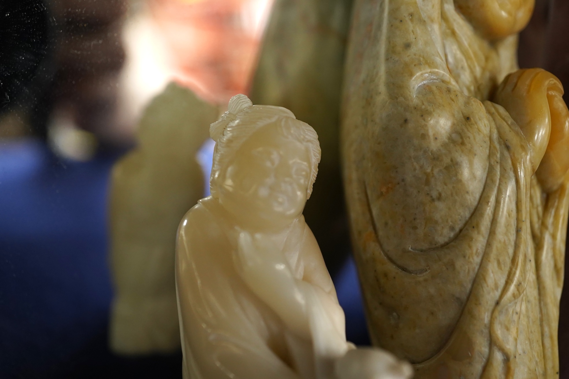 A Chinese white jade 'boys with jar' carving and three shoushan stone figures; luohan, girl with squirrel and mermaid (4), tallest 11cm